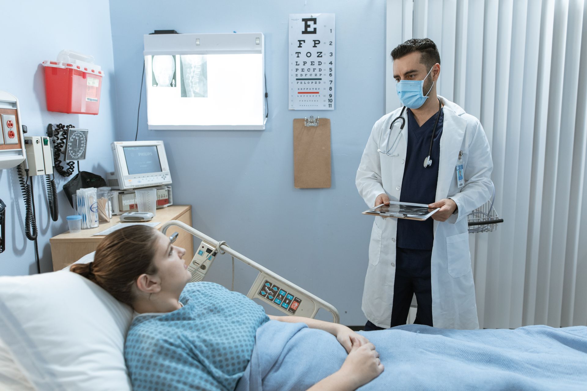Caregiver helping a bedridden patient with pressure care