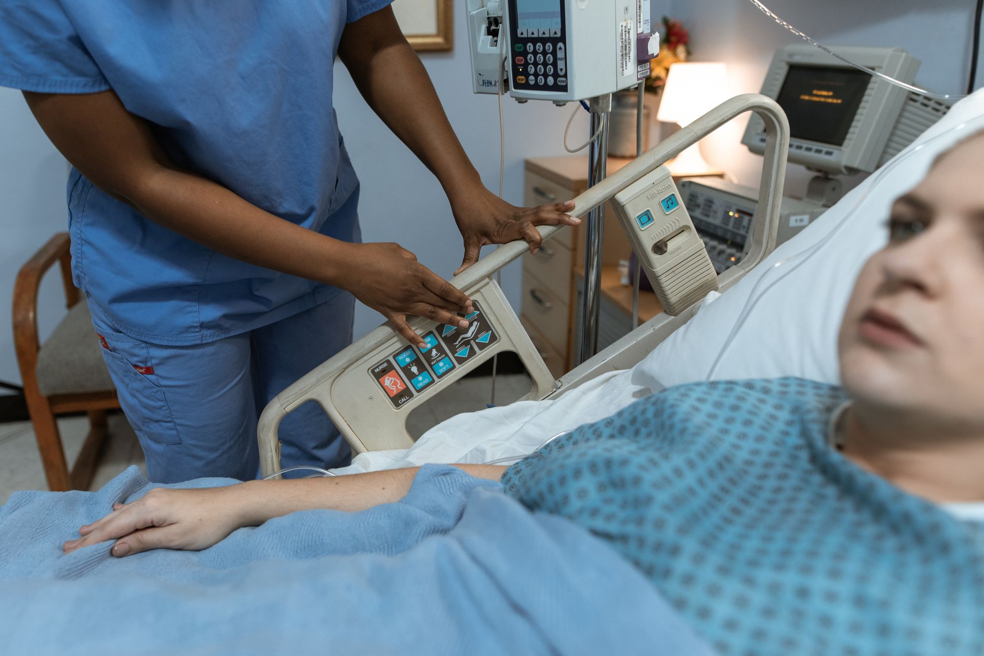 Caregiver repositioning a bedridden patient to reduce pressure pain and stiffness