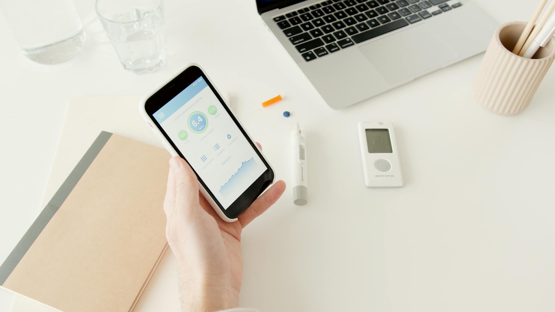 Person tracking blood sugar levels using a glucose monitoring app