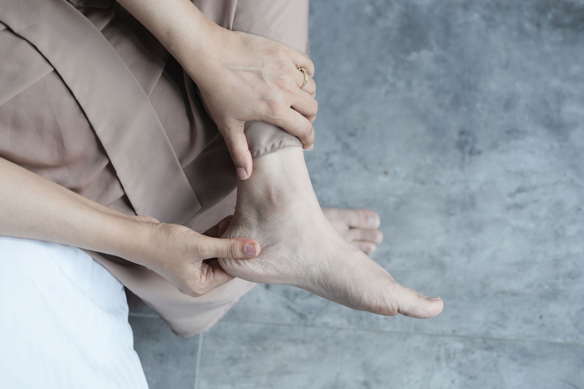 Person holding heel due to nerve-related heel pain