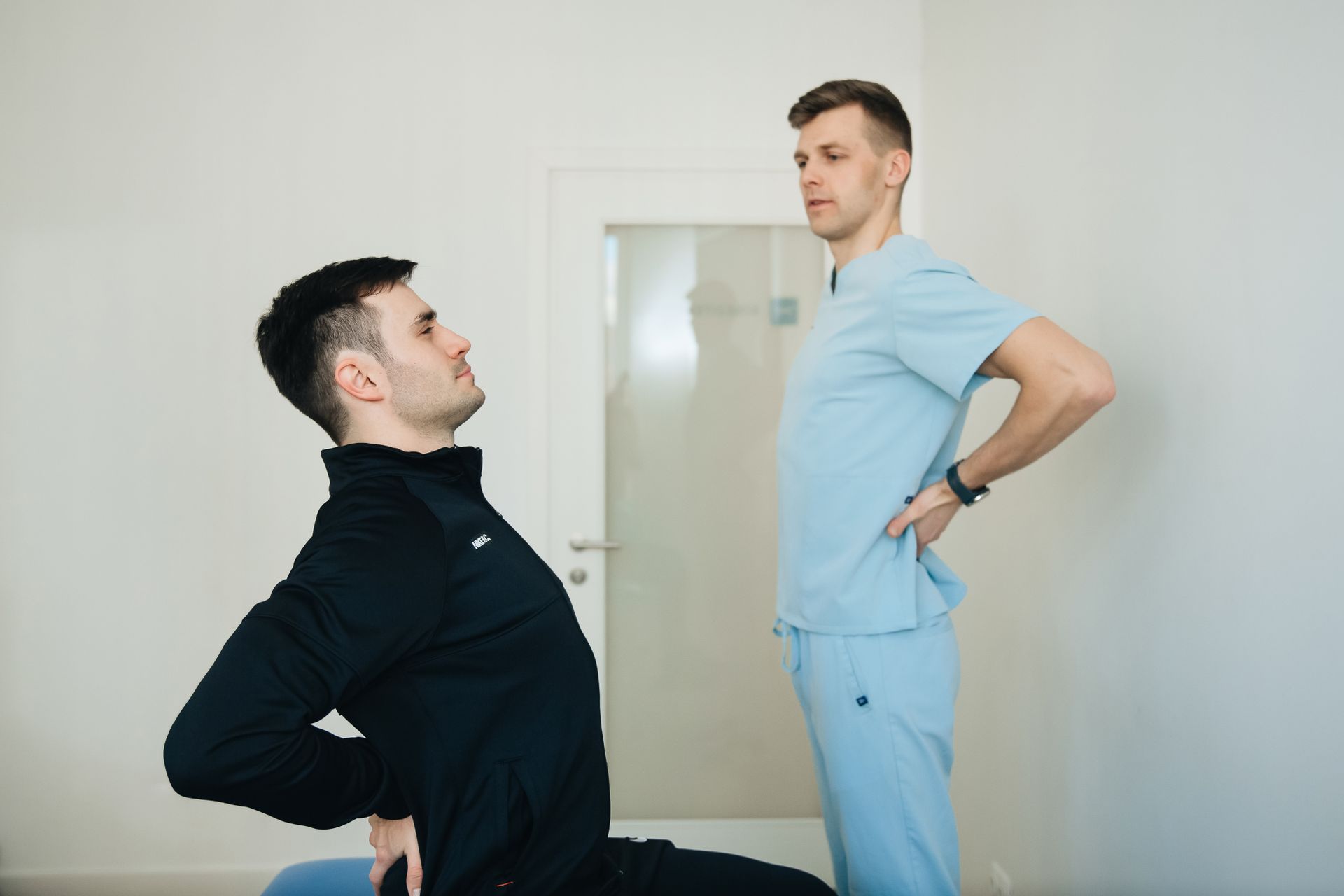 Person experiencing lower back pain while sitting