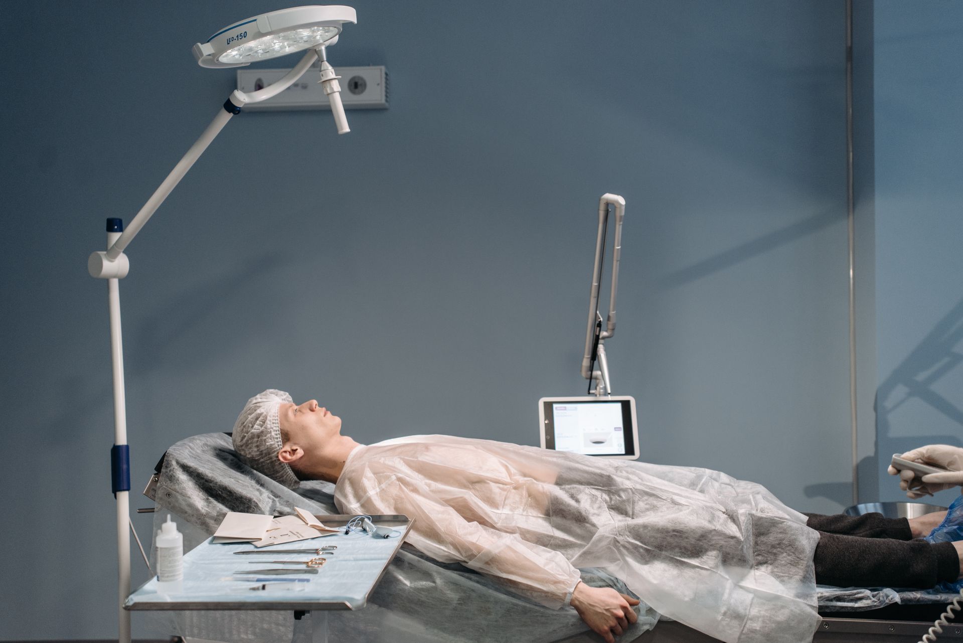 Doctor evaluating post-surgery scar sensitivity and pain