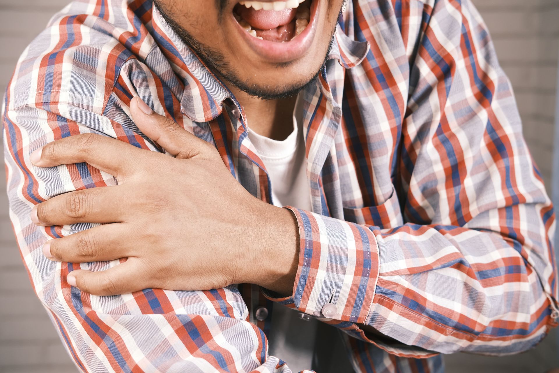 Person holding the abdomen while experiencing abdominal pain