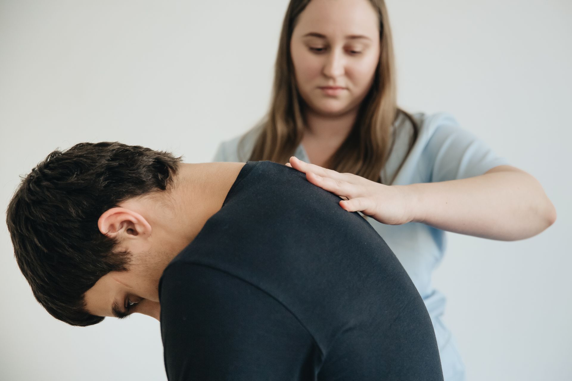 Doctor performing physical assessment for sciatica diagnosis