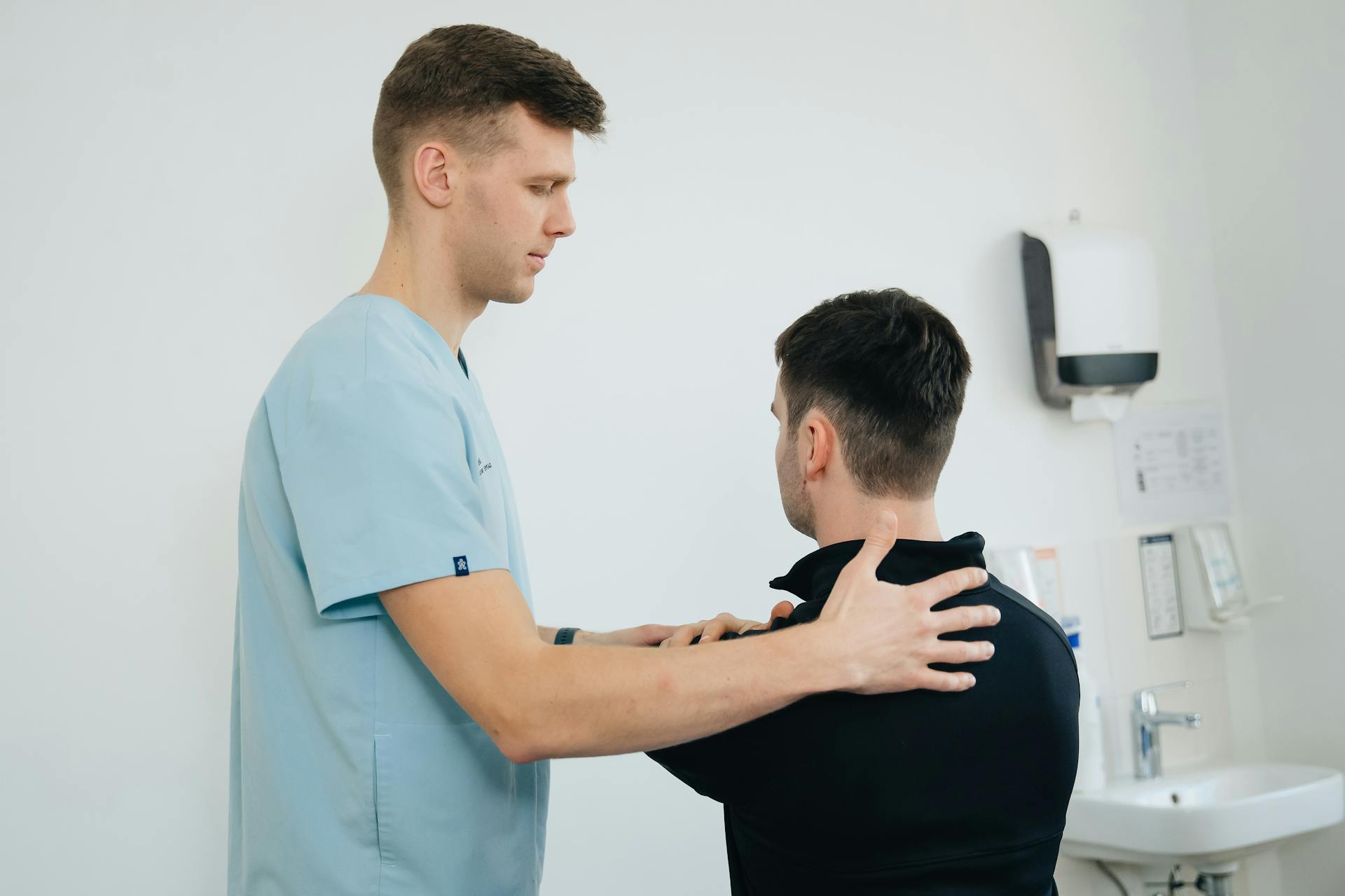 Doctor examining a patient with shoulder pain
