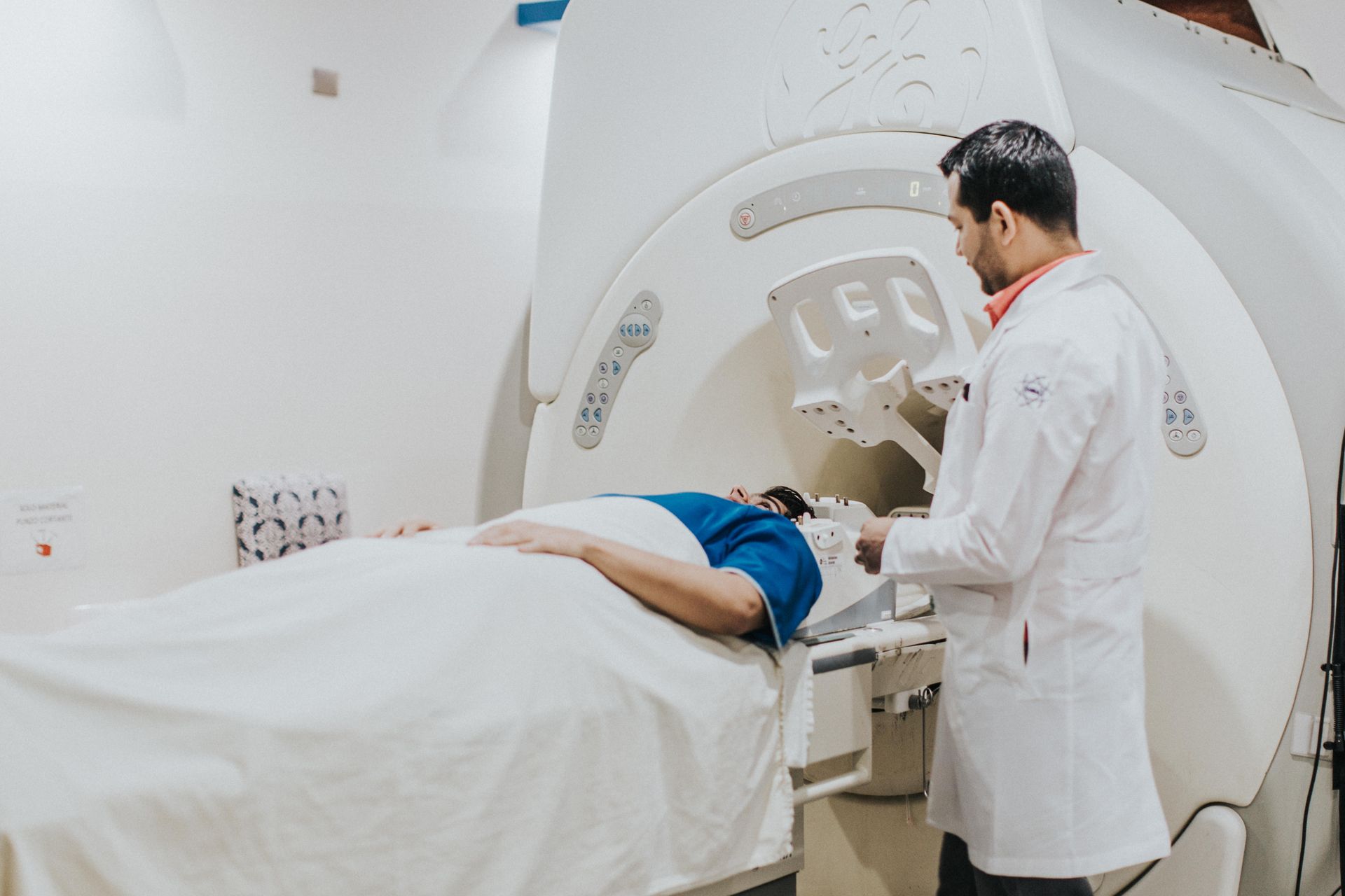 Doctor preparing patient for MRI evaluation of slipped disc symptoms