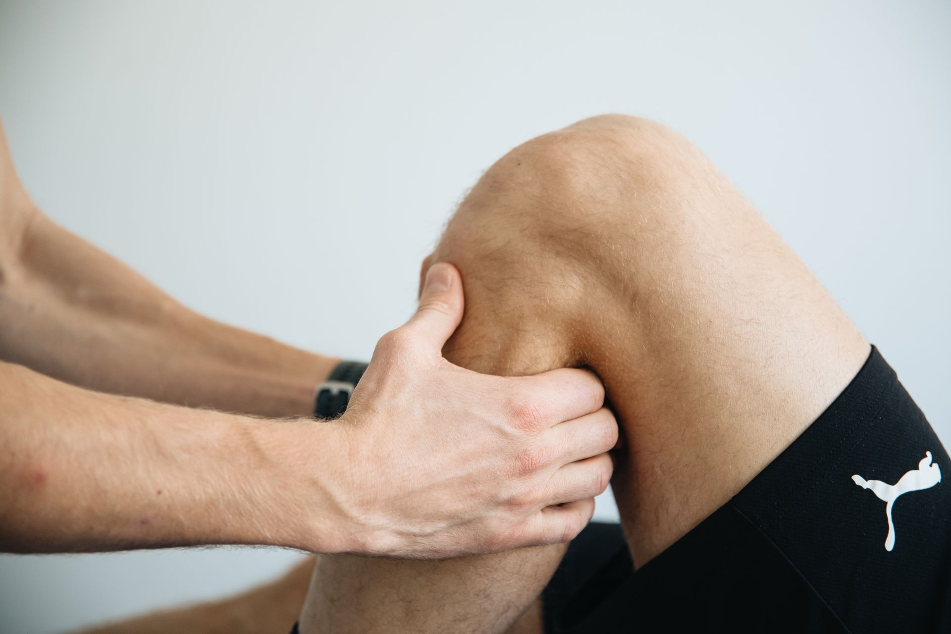 Doctor assessing thigh nerve pain and meralgia paresthetica symptoms